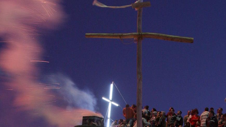 Fireworks explode over the Muslim and Christian Syrian town of Maloula, north of the capital Damascus, September 13, 2009, to celebrate the eve of the Feast of the Cross, to commemorate the cross used in the crucifixion of Jesus. REUTERS/Khaled al-Hariri    (SYRIA SOCIETY RELIGION IMAGES OF THE DAY)